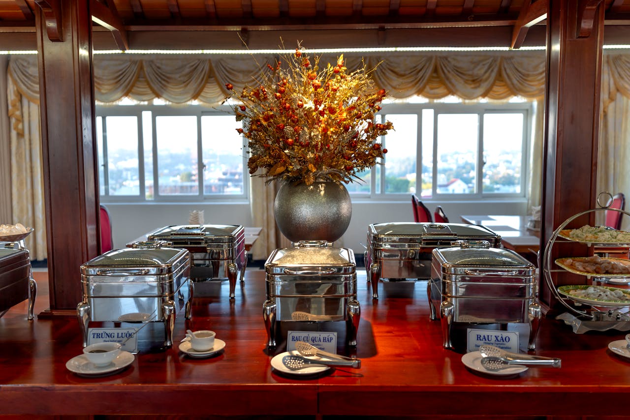 services-01 Luxurious buffet setup in an elegant dining room with decorative elements and ambient lighting.