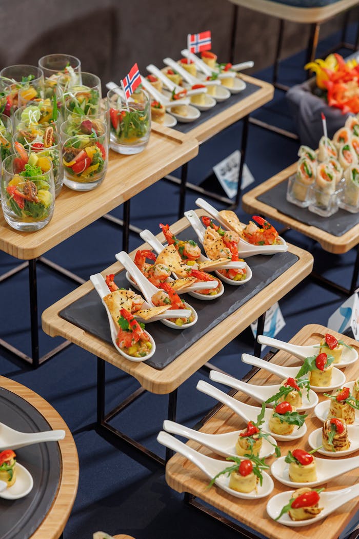 ours-journey A variety of gourmet appetizers elegantly arranged on a buffet table, featuring international flavors.